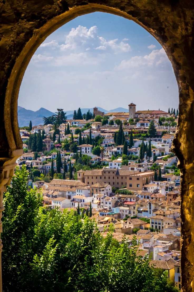 View of the Albaicín in Granada through a stone arch